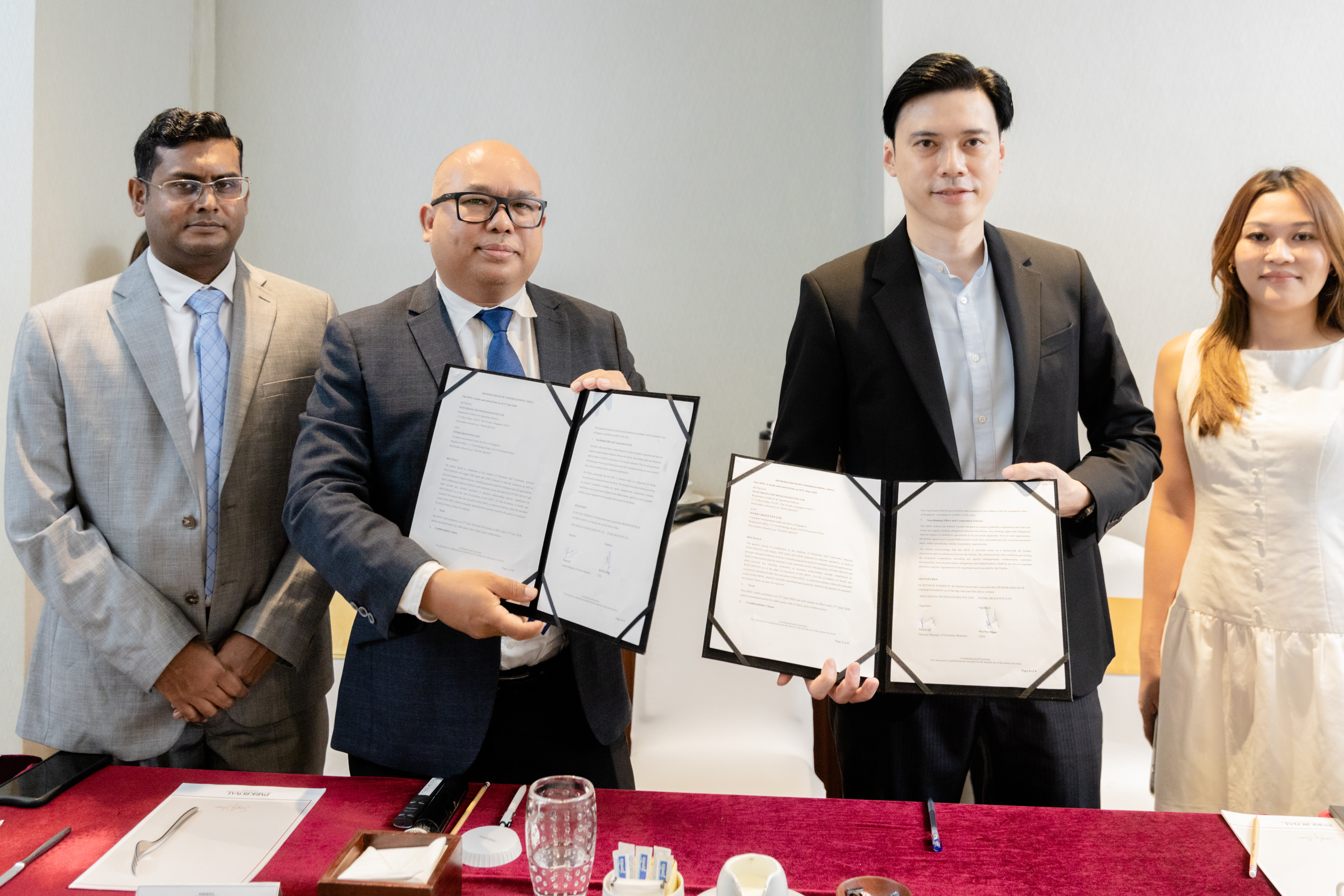 Inter Group and Watchdata Technologies representatives holding signed MOU documents